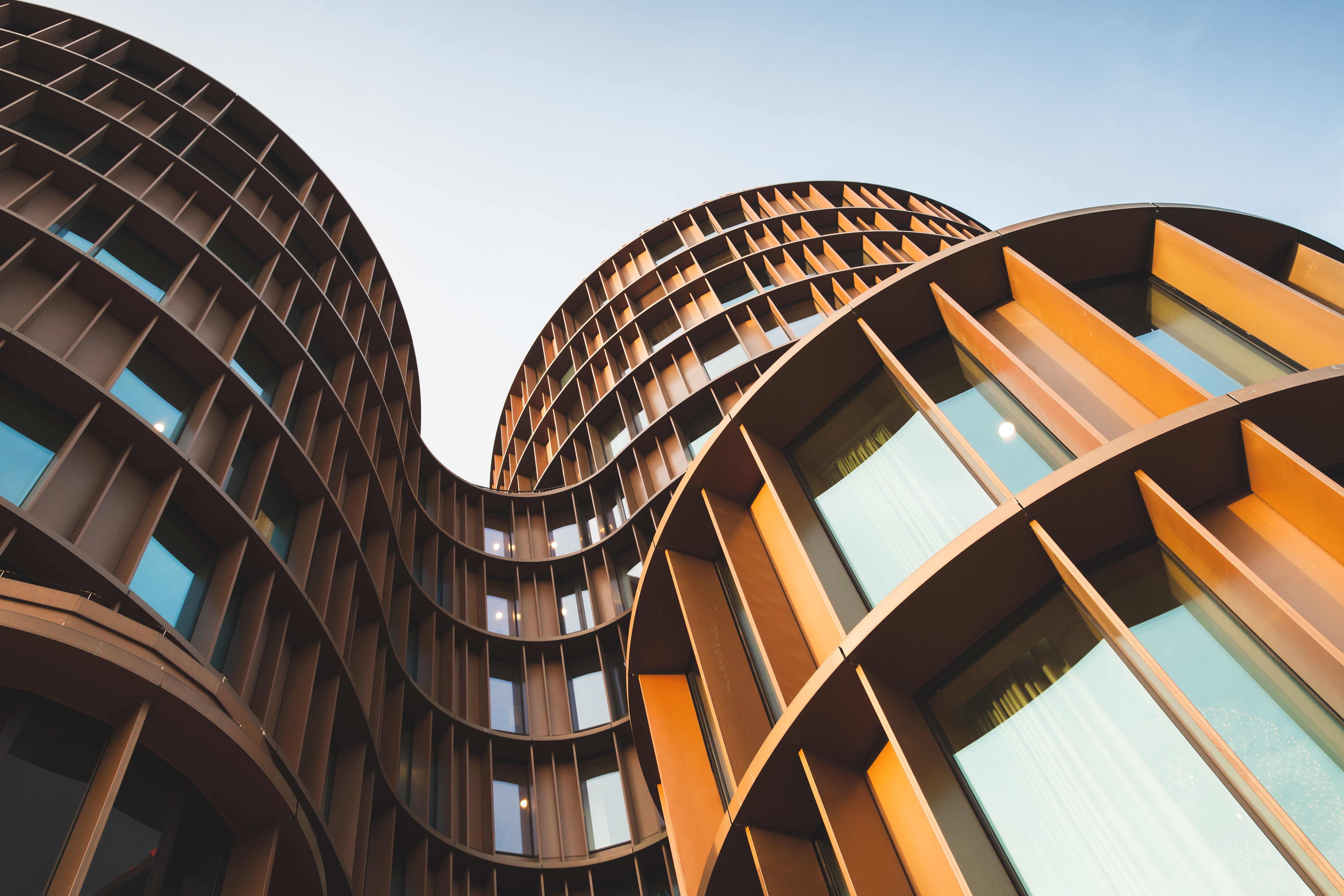 Abstract contemporary architecture background, round towers made of yellow shiny metal and glass